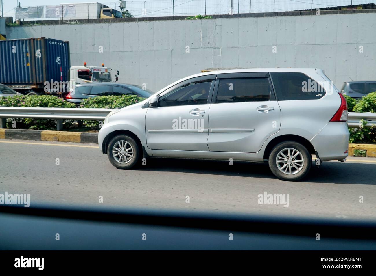 Voiture Toyota Avanza argent clair dans la route périphérique extérieure de l'autoroute, Jakarta, Indonésie. Banque D'Images