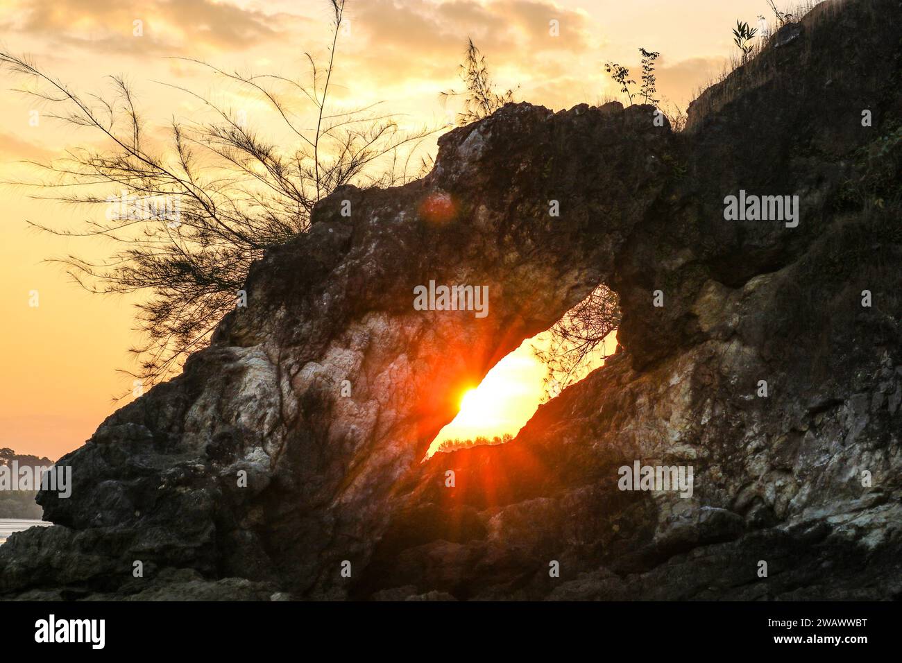 Coucher du soleil dans une arche de pierres calcaires au bord de la mer. Banque D'Images