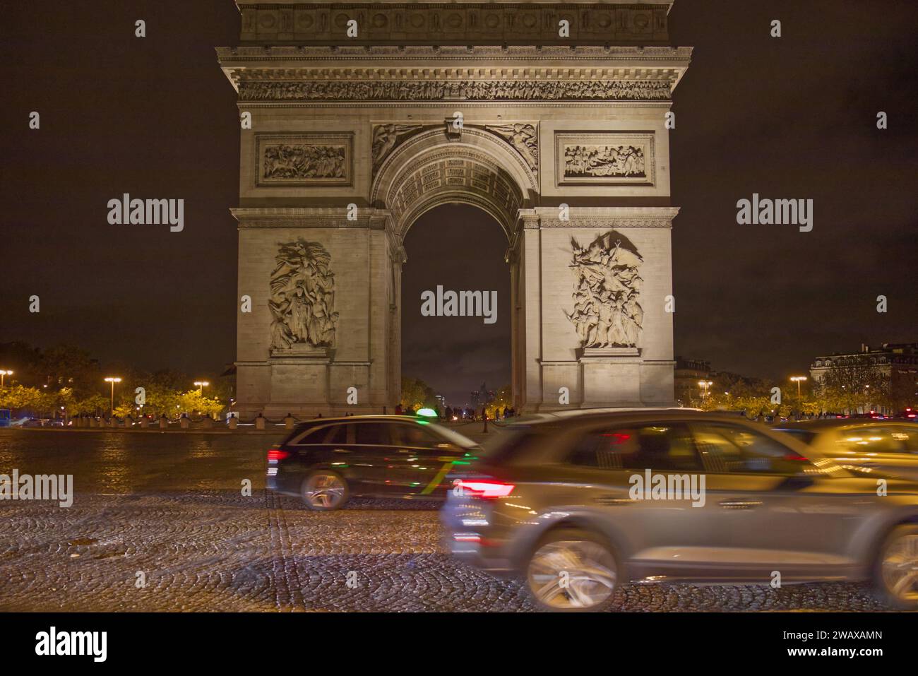 Place Charles de Gaulle ou place de l'étoile, Paris, France - Arc de Triomphe monument de l'arc de triomphe avec des voitures l'encerclant la nuit Banque D'Images