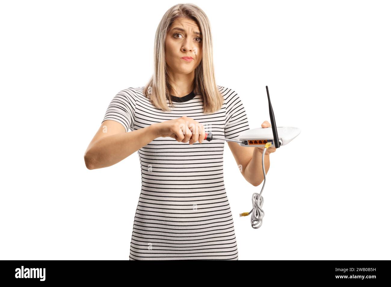 Grincheux jeune femme fixant un routeur isolé sur fond blanc Banque D'Images Grincheux jeune femme fixant un routeur isolé sur fond blanc Banque D'Images