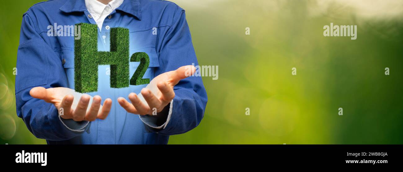 L'ingénieur tient le symbole de l'hydrogène H2 de l'herbe. Banque D'Images
