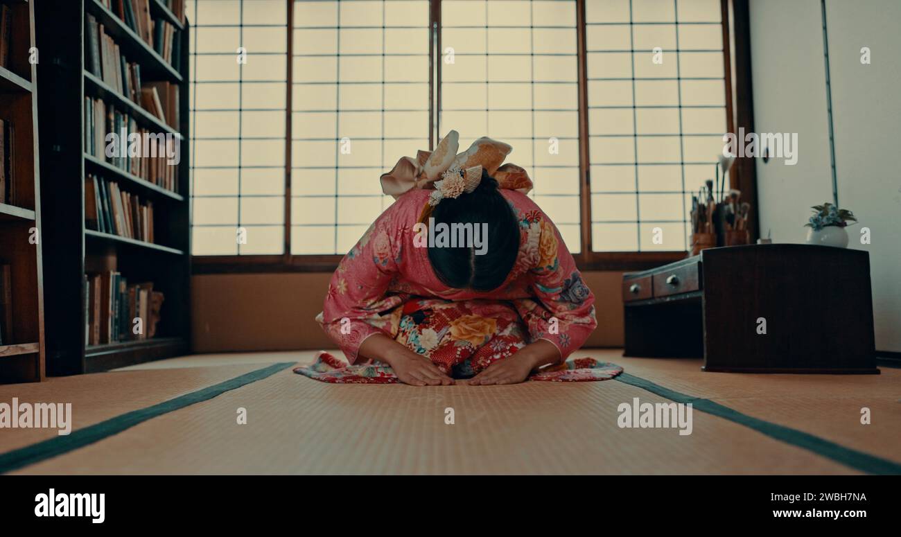 Femme, prière et religion japonaise ou spirituelle dans la salle de tatami pour la culture traditionnelle, le respect ou le rituel. Personne asiatique, agenouillement et kimono pratique ou Banque D'Images