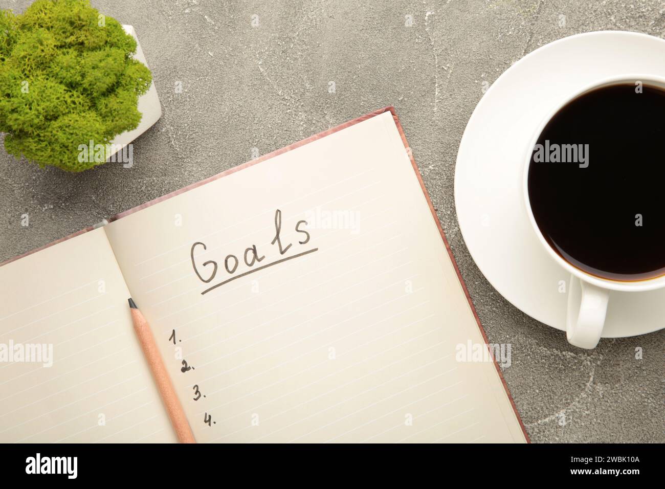 Mes objectifs comme mémo sur cahier avec tasse de café sur fond gris. Vue de dessus. Banque D'Images