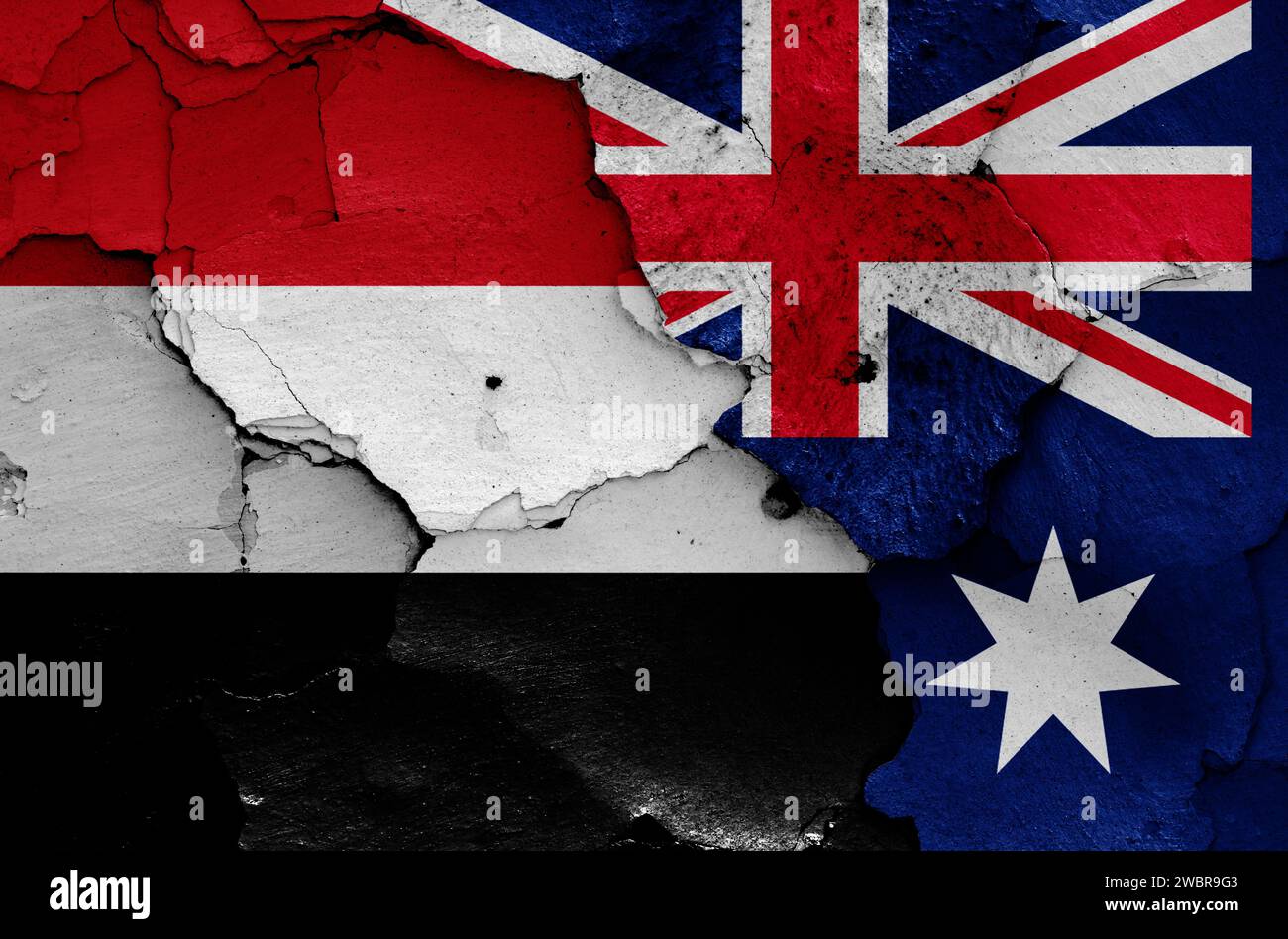 Drapeaux du Yémen et de l'Australie peints sur un mur fissuré Banque D'Images