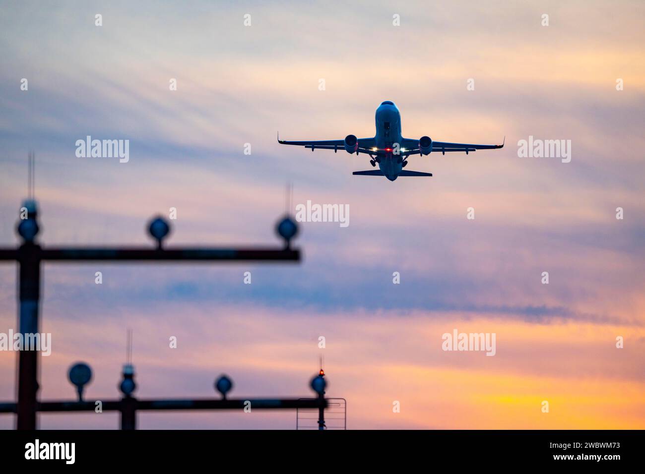 Balisage lumineux de piste, aides à l'approche, à l'aéroport international de Düsseldorf, coucher de soleil, avion décollant de la piste principale sud, 05R/23L, NRW, Allemagne, Banque D'Images