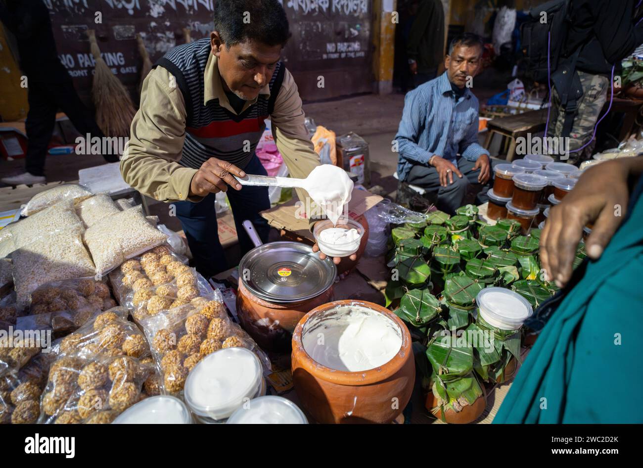 Vendeur vendant de la nourriture traditionnelle assamaise sur un marché, avant le festival Magh Bihu à Guwahati, Assam, Inde, le 13 janvier 2024. Magh Bihu marque la fin de la saison de récolte, en particulier la récolte du paddy, et le début du mois assamais de Magh. Le festival tombe généralement à la mi-janvier, et c'est un moment de joie et de festin. Les gens expriment leur gratitude pour la récolte abondante et prient pour la prospérité dans les saisons à venir. Crédit : David Talukdar/Alamy Live News Banque D'Images