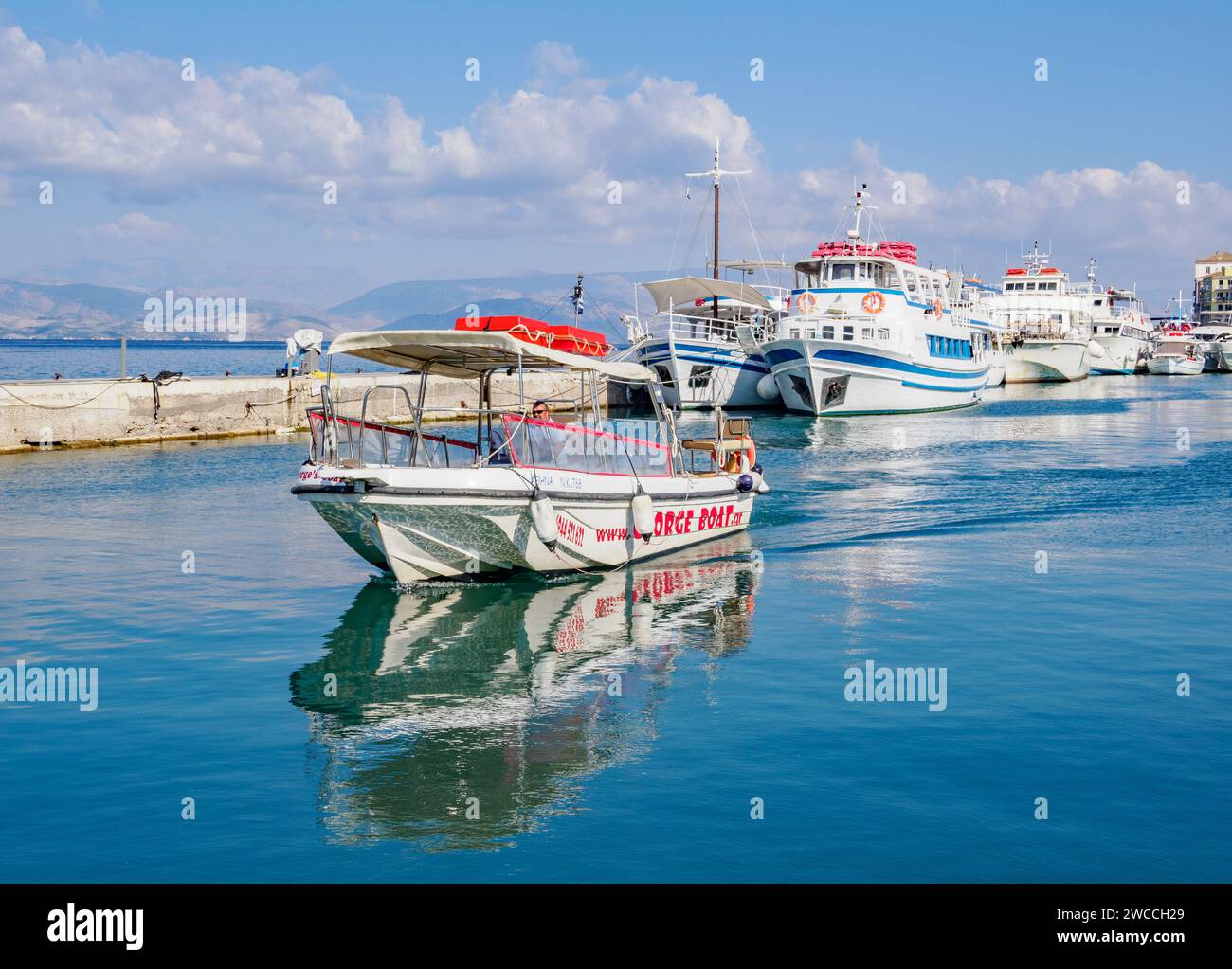 George Boat un service local de bateau-taxi géré par le capitaine George le long de la côte nord-ouest de Corfou Grèce ici en direction du vieux port de Corfou Banque D'Images