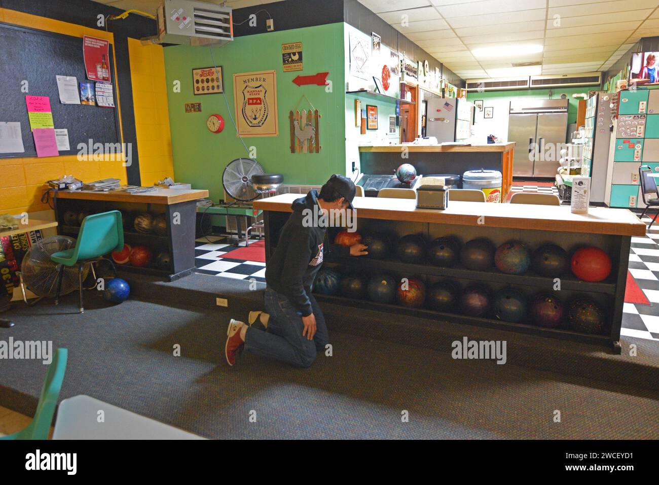 Gen Z jeune homme choisissant une boule de bowling au Dighton Bowl à Dighton Kansas - mai 2023 Banque D'Images