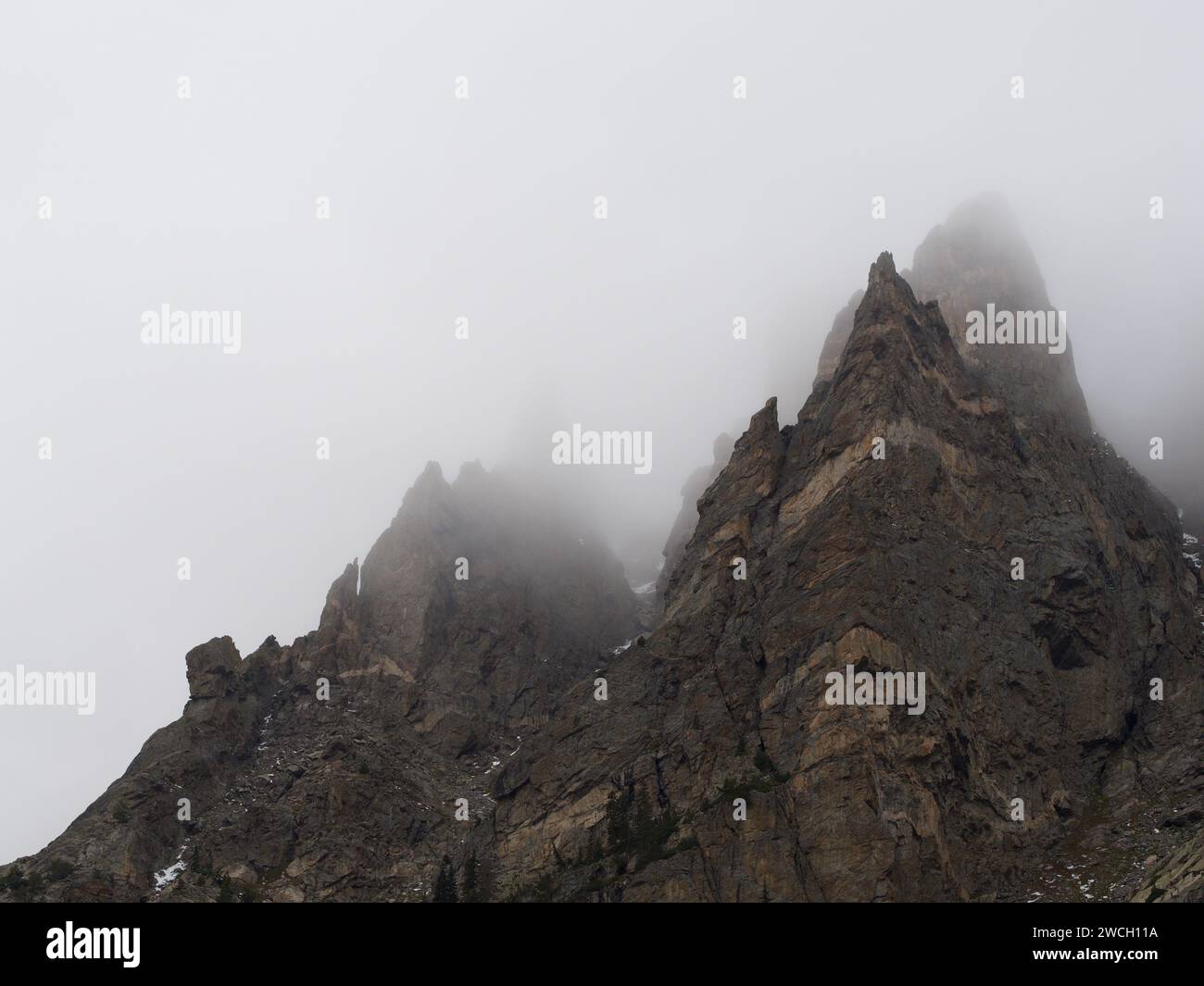 Un paysage à couper le souffle avec des montagnes couvertes de brume ornées d'une couverture de nuages Banque D'Images