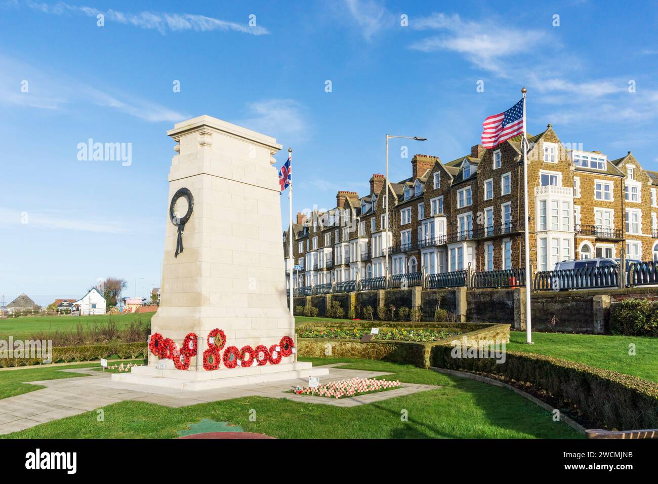 Les drapeaux britanniques et américains flottent à côté du monument aux morts sur la falaise de Hunstanton dans le Norfolk. Banque D'Images