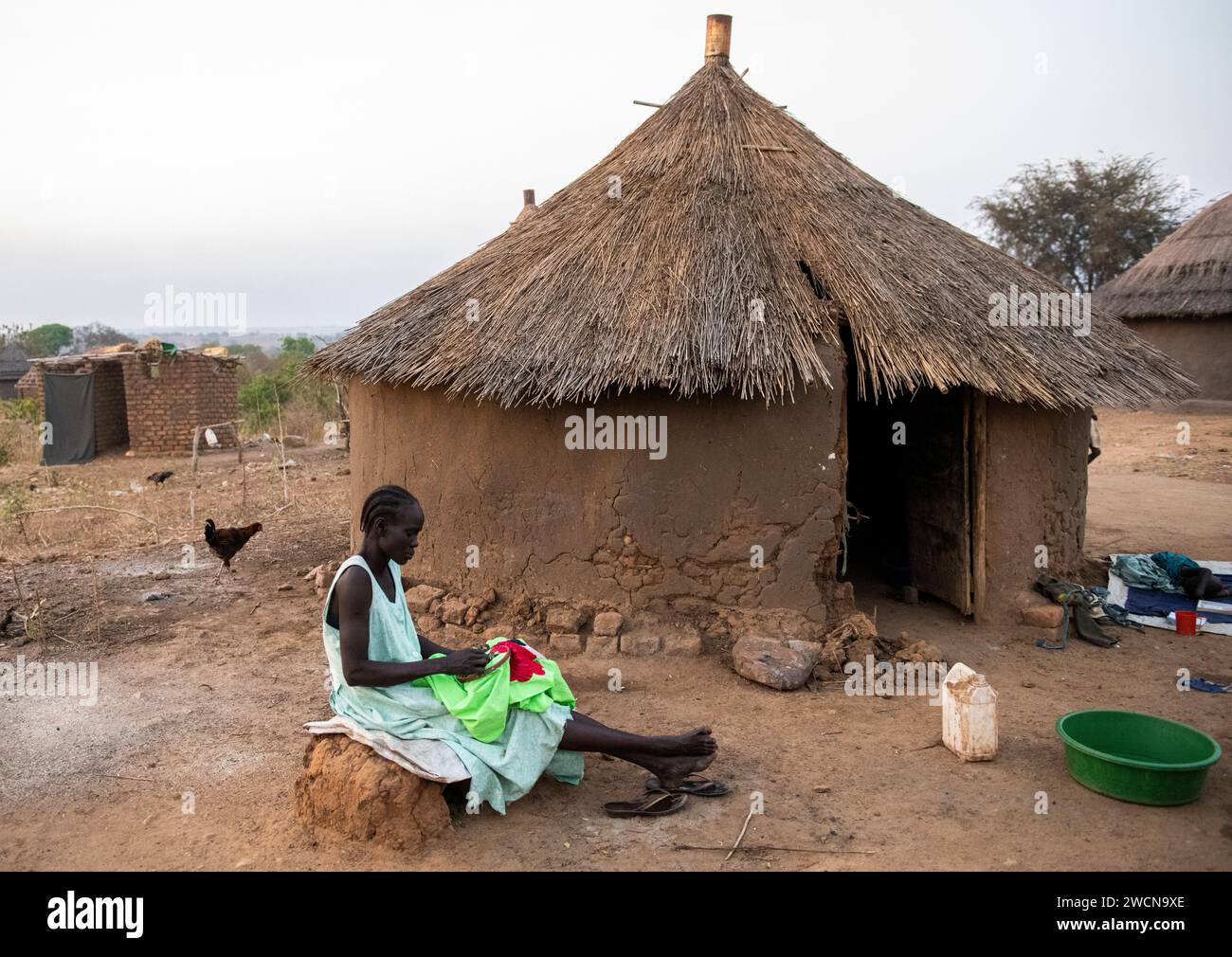 Ouganda, Adjumani. Une femme croise devant sa maison. Usage éditorial uniquement. Banque D'Images