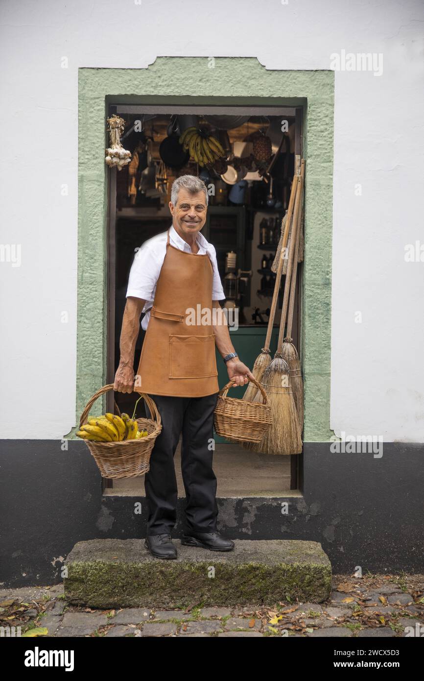 Portugal, archipel des Açores, île de Terceira, Gilberto Vieira le propriétaire de Quinta do Martelo, une ancienne ferme transformée en complexe écotouristique rural, devant l'entrée de sa tasca, une taverne reconstituée Banque D'Images