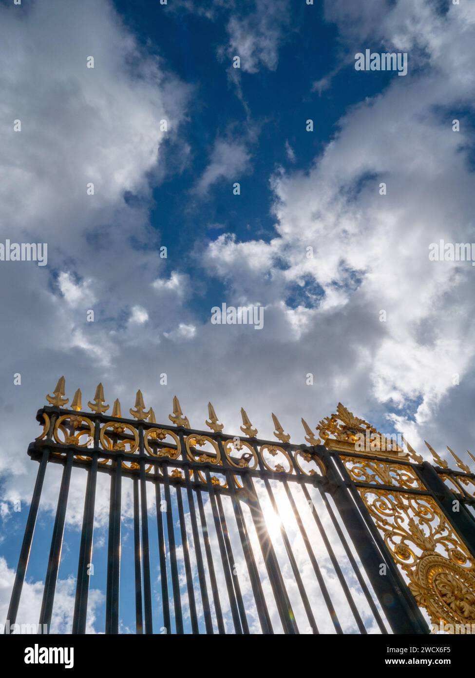 Vue depuis une clôture métallique avec des pointes dorées dans le ciel de Paris. Banque D'Images