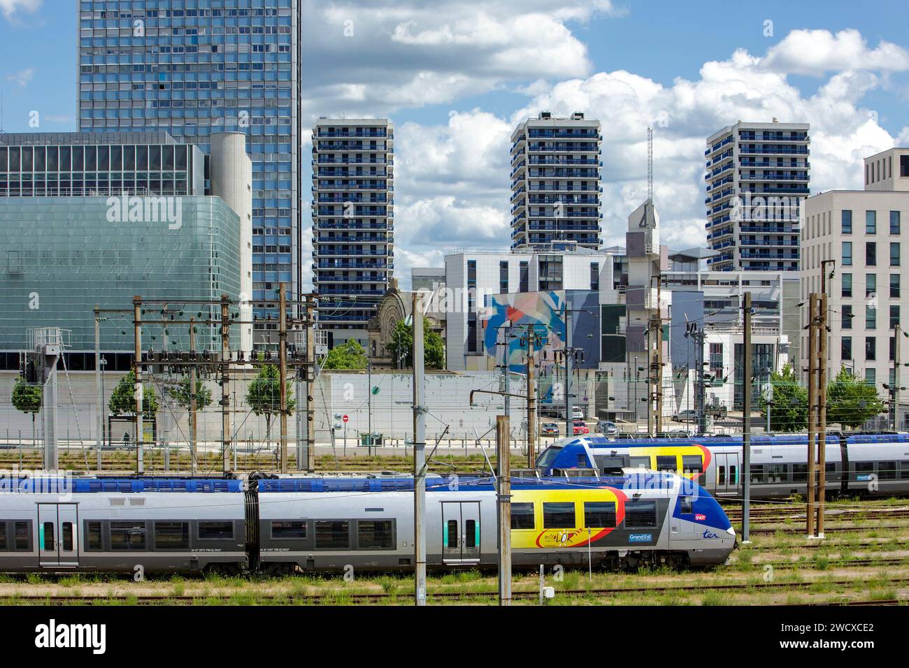 France, Meurthe et Moselle, Nancy, quartier de la gare, TER (trains express régionaux) stationné, la caserne de pompiers avec sa façade Street art de l'artiste américain MOMO, les immeubles d'appartements Saint Sebastien Towers et la gare Nancy ville Banque D'Images