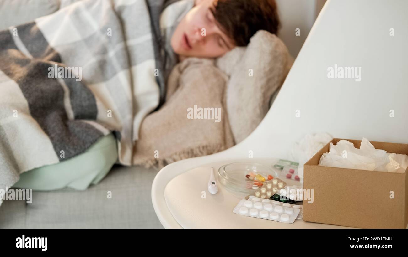 Comprimés de récupération à domicile de traitement froid homme plaid Banque D'Images