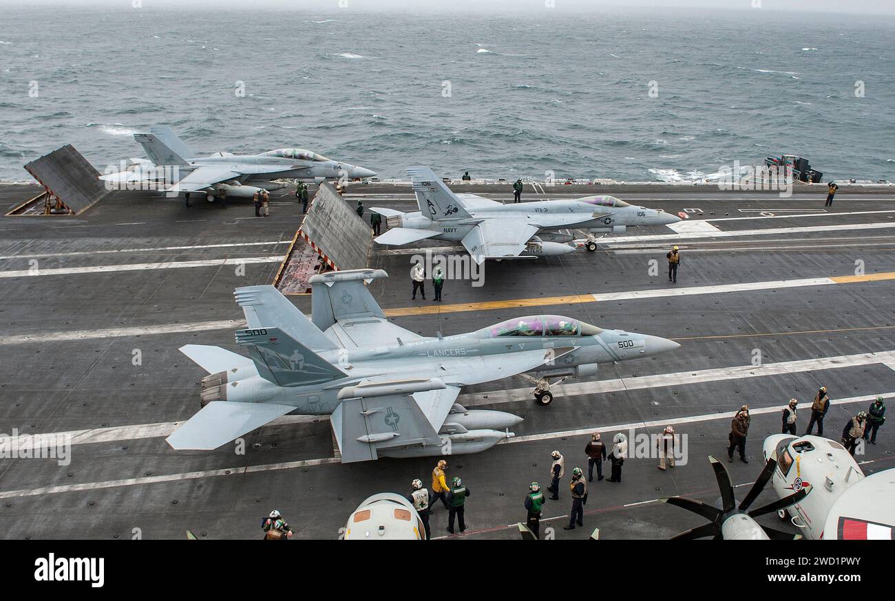 Les marins dirigent les avions sur le pont d'envol de l'USS George H.W. Bush. Banque D'Images