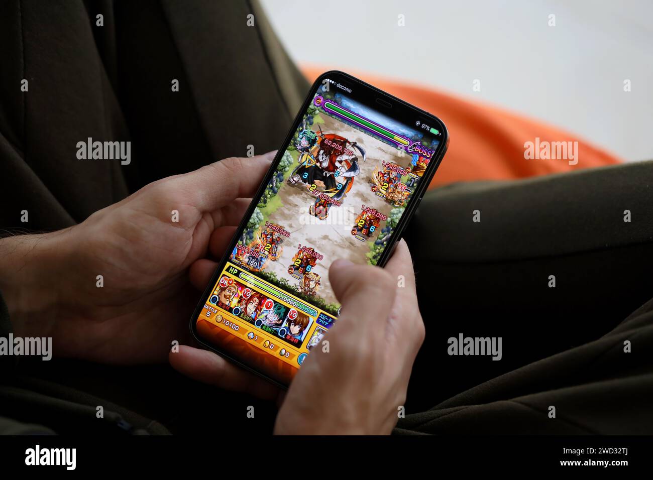 Monster Strike mobile iOS jeu sur iPhone 15 écran de smartphone dans les mains masculines pendant le gameplay mobile. Jeux et divertissements mobiles sur un appareil portable Banque D'Images