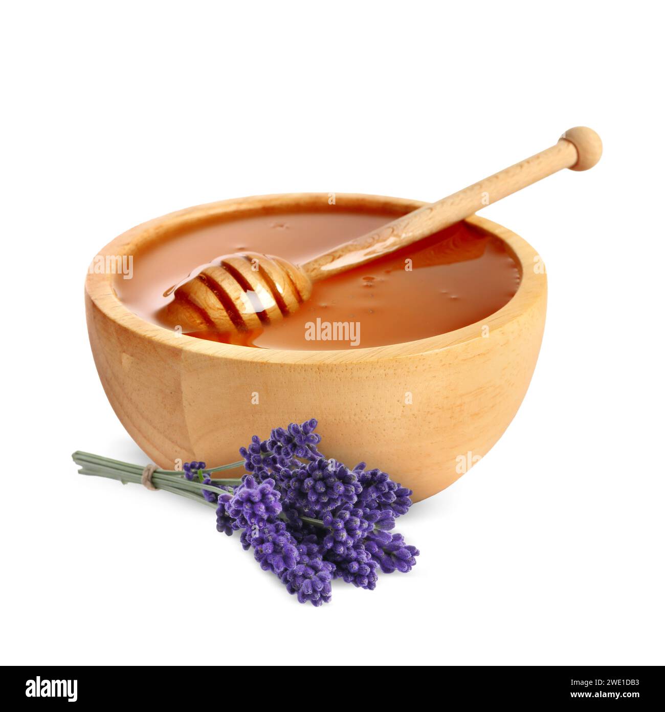 Miel dans un bol en bois, Dipper et fleurs de lavande isolées sur blanc Banque D'Images