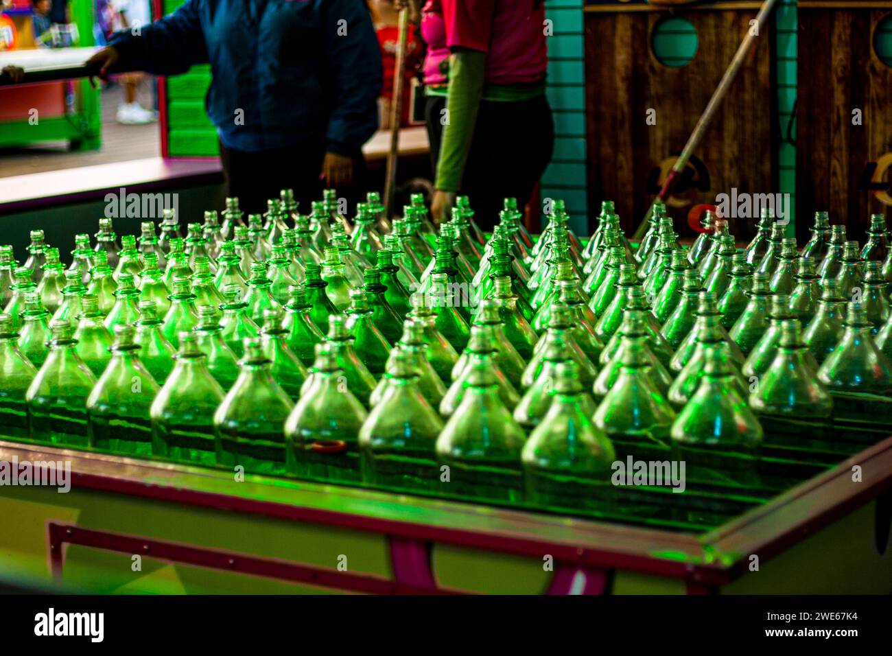 Bouteilles de verre vert dans un jeu de lancer d'anneau à un carnaval ou une foire Banque D'Images