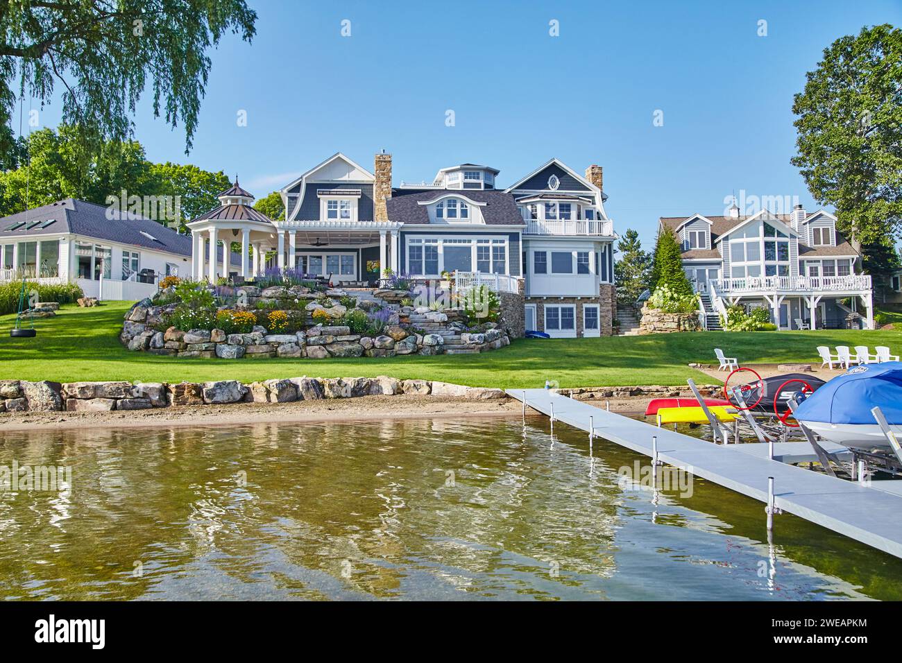 Luxueuse résidence au bord du lac avec jardins bien entretenus et vue sur le quai Banque D'Images