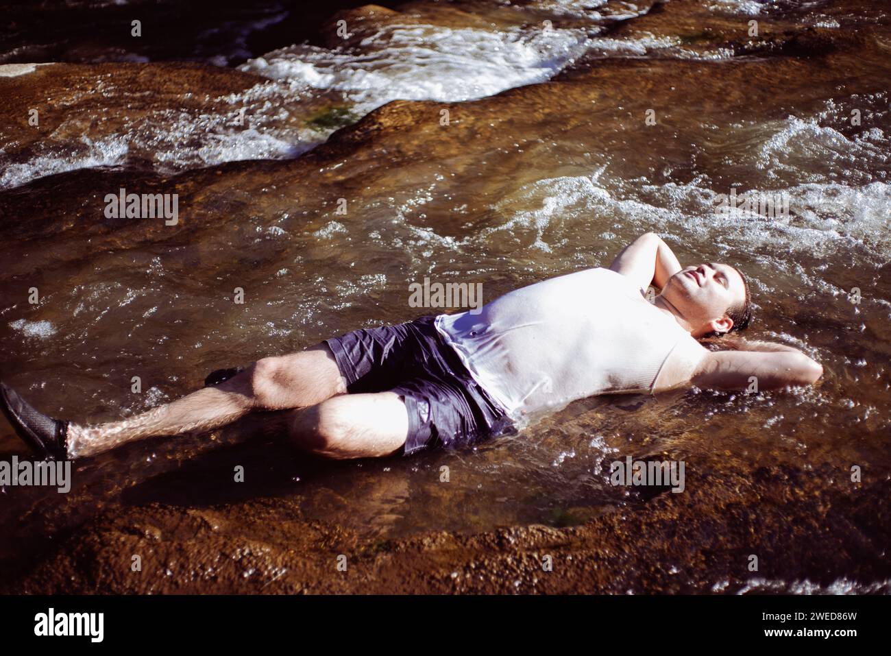 Un moment de détente dans le parc national d'Ohiopyle : un ami allongé sur le dos dans l'eau, profitant de la beauté tranquille tout en randonnant dans la nature sauvage de PA Banque D'Images