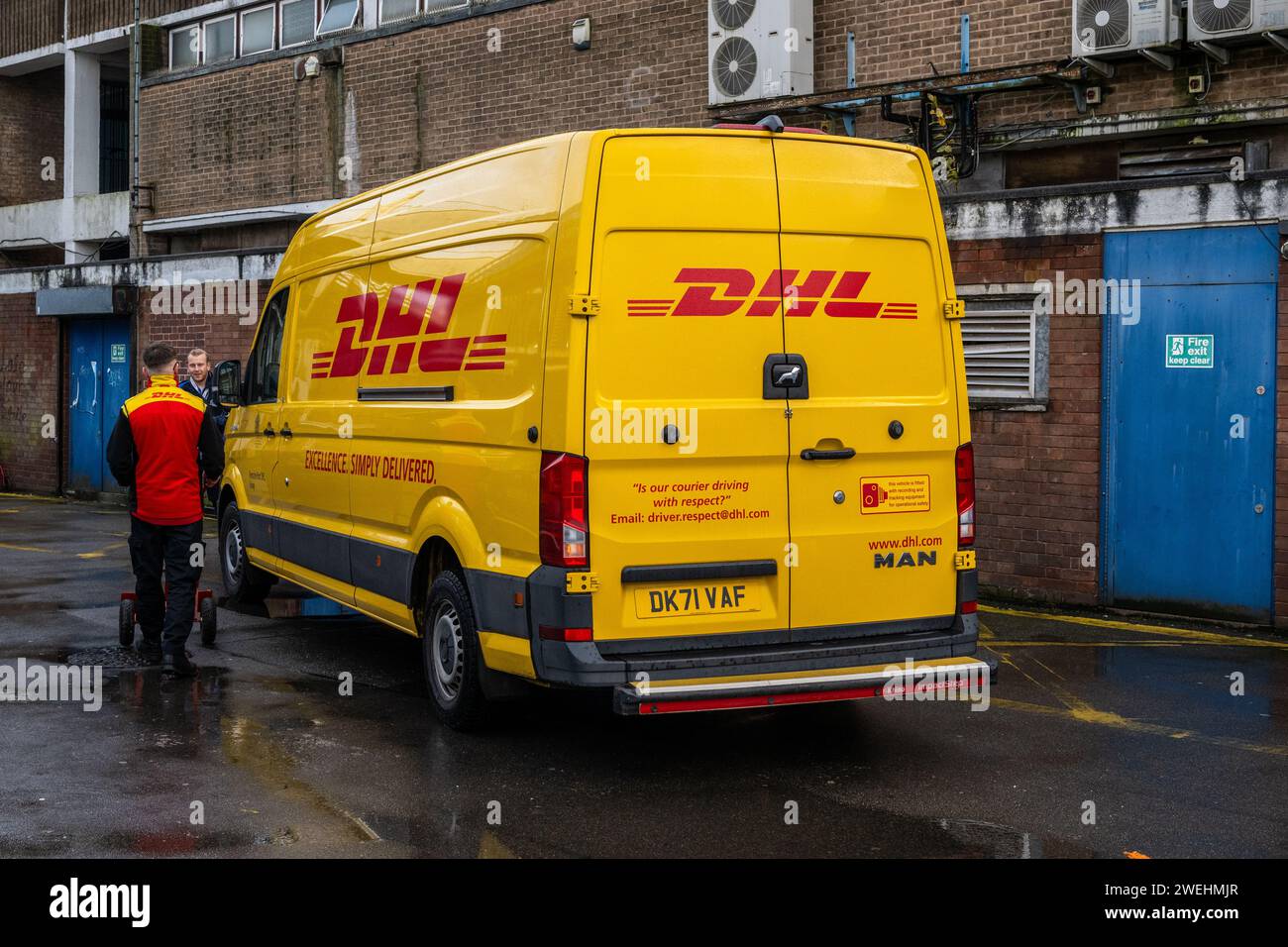 Chauffeur de livraison DHL et fourgon de livraison à Coventry, West Midlands, Royaume-Uni. Banque D'Images
