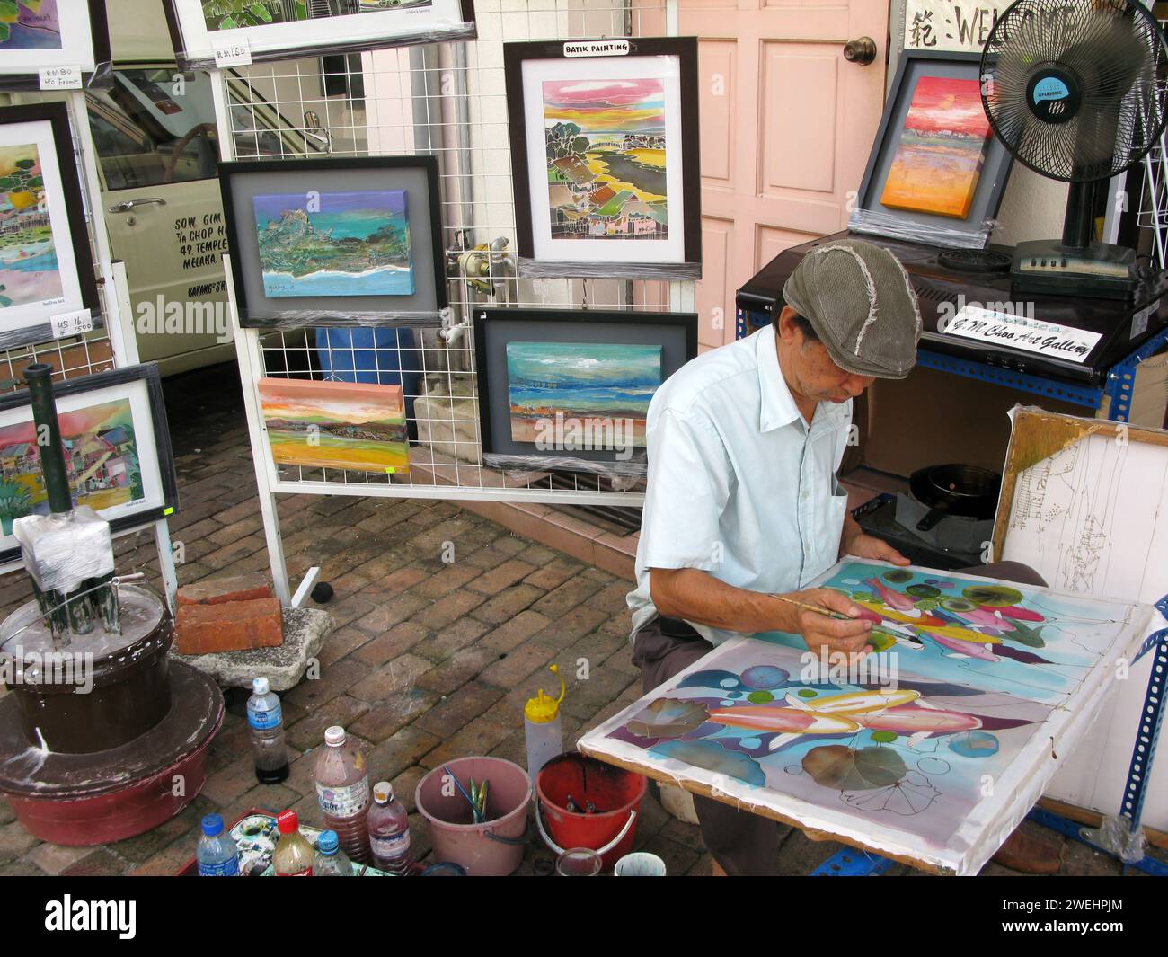 Un artiste au travail à Melaka City dans l’État de Malacca en Malaisie. Banque D'Images