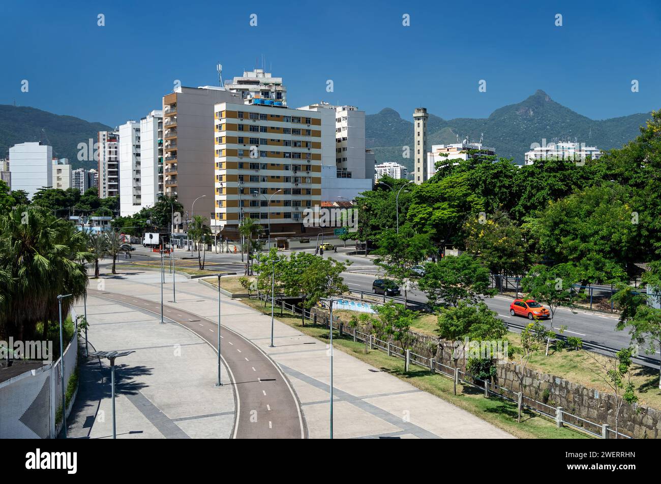 Une piste cyclable courbe qui relie le stade Maracana à l'avenue du Professeur Manoel de Abreu avec les bâtiments du quartier Maracana derrière sous le ciel bleu. Banque D'Images