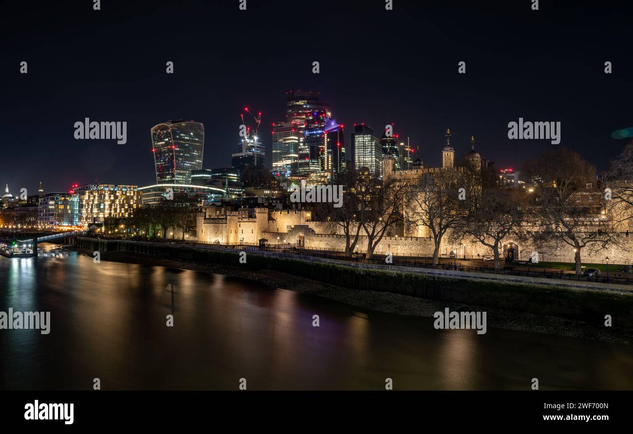 Londres. UK-01.27.2024. Une vue générale de la Tour de Londres la nuit avec des gratte-ciel dans la City de Londres en arrière-plan. Banque D'Images