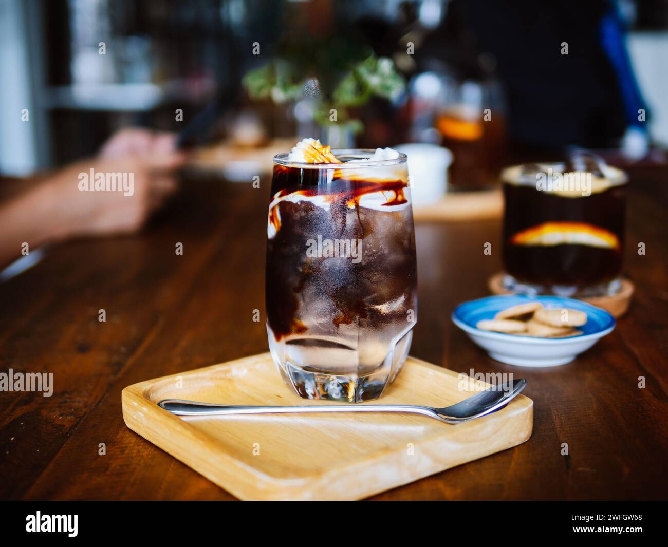 Coconut américain glacé. Un verre clair de couche glacé americano avec de l'eau de coco fraîche jeune et de la viande de coco sur la table, une boisson fraîche d'été et la maison b Banque D'Images