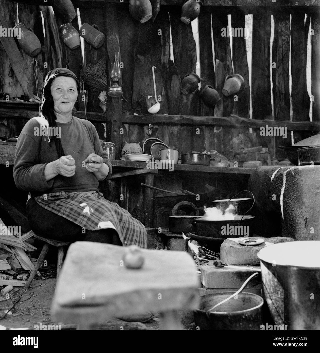 Comté de Vrancea, République socialiste de Roumanie, env. 1978. Femme cuisinant dans sa cuisine d'été dans un four en terre authentique. Banque D'Images