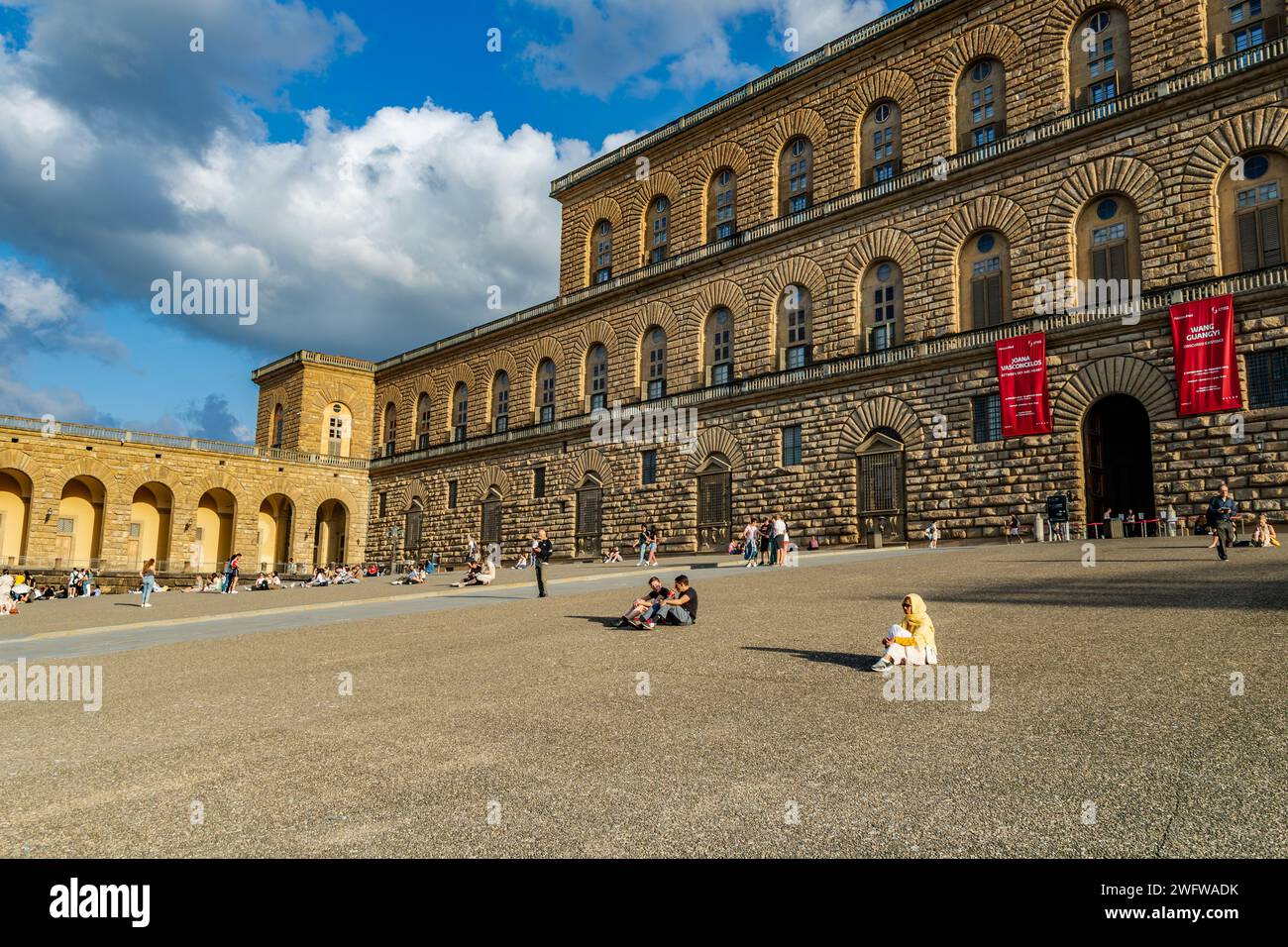 Les gens assis sur la cour dans le soleil de fin d'après-midi au Palais Pitti à Florence , Italie Banque D'Images
