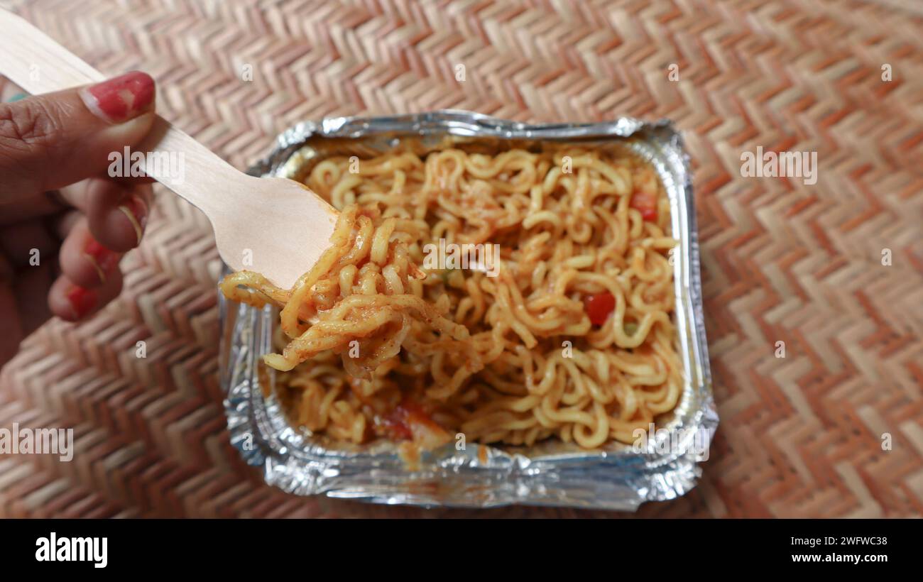 Tasty Vegetable Maggi colis de livraison de nourriture dans une boîte en aluminium. Nouilles instantanées Maggie tadka à la tomate, oignon, capsicum Banque D'Images