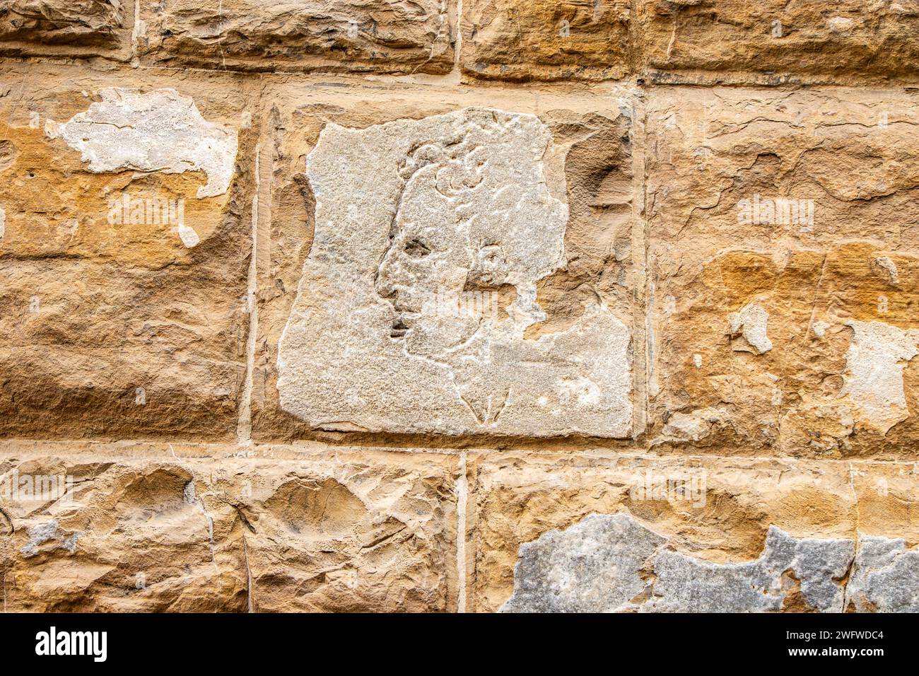 Gravé dans les murs de pierre de l'hôtel de ville historique de Florence, considéré par certains comme Michel-Ange, Florence, Italie Banque D'Images