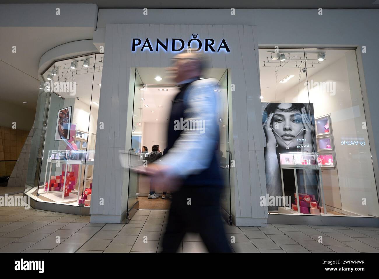 New York, États-Unis. 01 février 2024. Un homme passe devant un magasin de bijoux Pandora, New York, NY, 1 février 2024. Pandora, le plus grand joaillier au monde, a annoncé son intention de passer à 100 % d'or et d'argent recyclés pour des articles clés tels que des bracelets et des colliers d'ici la mi-2024 ; la société estime qu'elle économisera 58 000 unités métriques d'émissions de dioxyde de carbone. (Photo Anthony Behar/Sipa USA) crédit : SIPA USA/Alamy Live News Banque D'Images