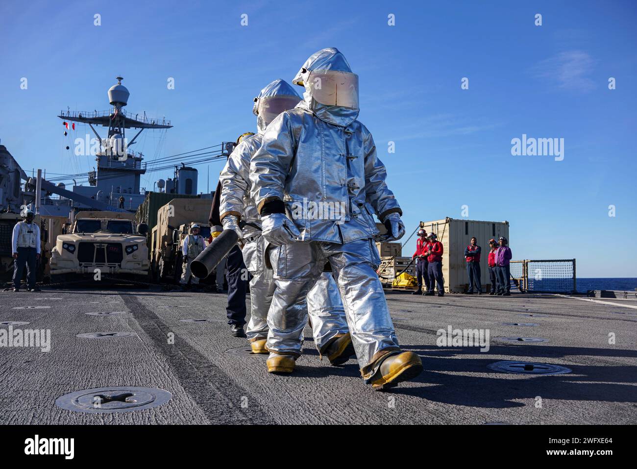 Le marin Jerry Cruz, à droite, de Brooklyn, New York, Controlman 1st Class Joseph Janelle, d'Apple Valley, en Californie, répond à un incendie simulé dans des combinaisons de proximité avec un outil Halligan et un extincteur à bord du navire amphibie de débarquement à quai USS Harpers Ferry (LSD 49), alors qu'il se dirigeait dans l'océan Pacifique, le 11 janvier 2024. Le Boxer Amphibious Ready Group, composé de l'USS Boxer (LHD 4), de l'USS Somerset (LPD 25) et de Harpers Ferry, et de la 15e Marine Expeditionary Unit embarquée, mènent des opérations de routine et d'entraînement intégrées dans la 3e flotte américaine. Banque D'Images