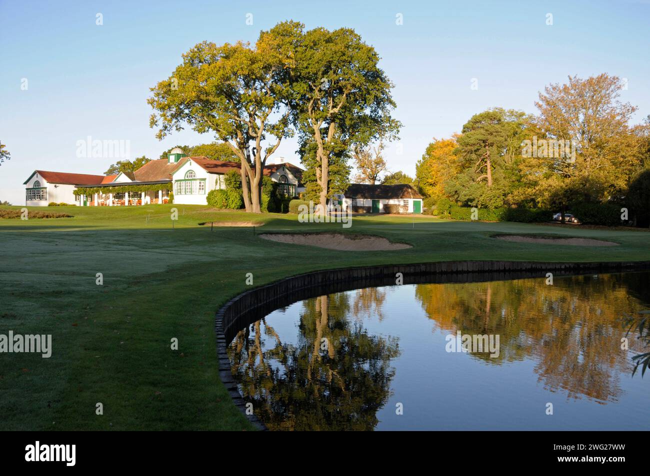 Vue tôt le matin sur l'étang au 18th Green et le Clubhouse, Woking Golf Club ; Woking ; Surrey ; Angleterre. Banque D'Images