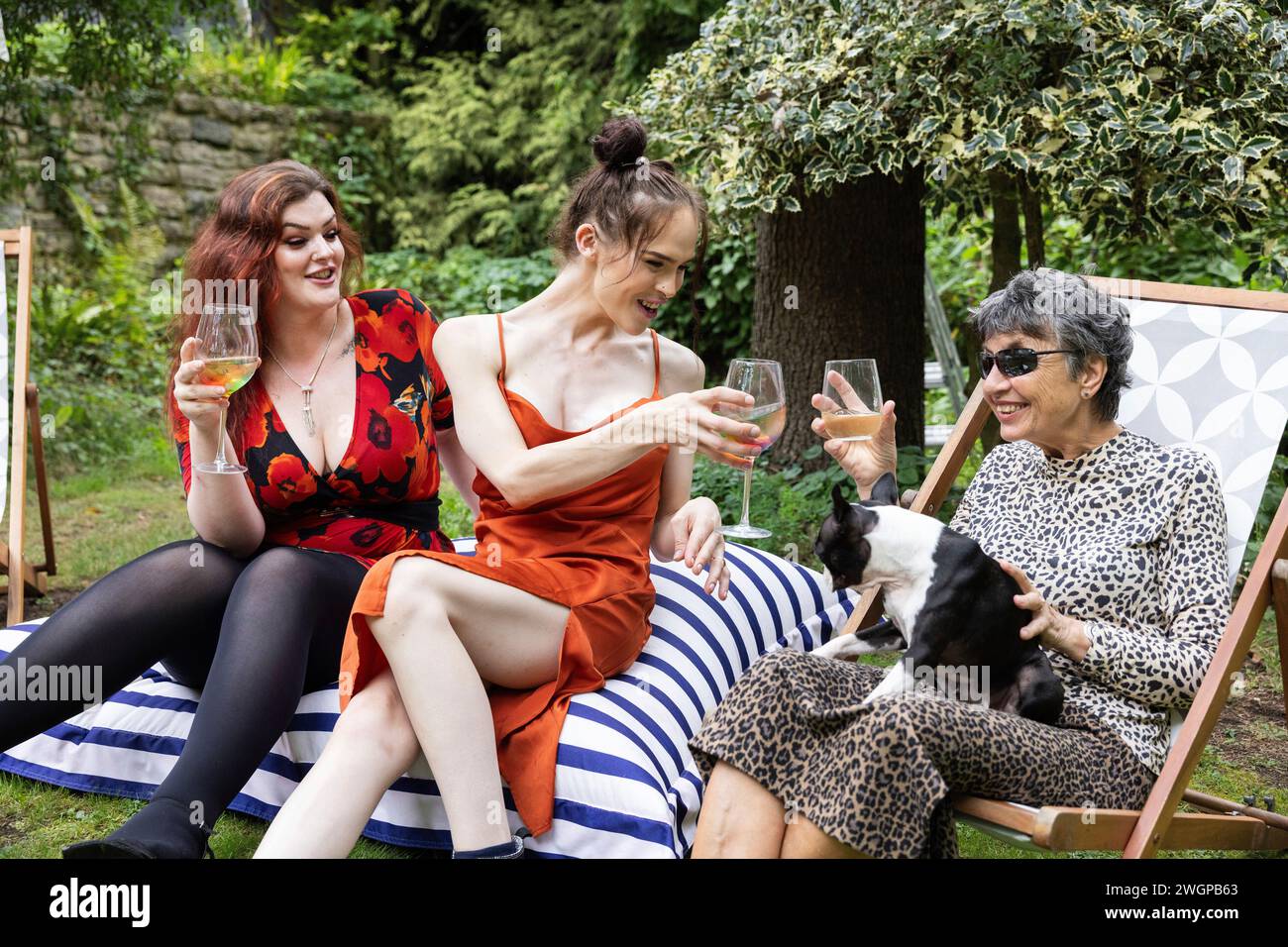 Groupe mixte d'amis féminins et de réunion de famille pour s'amuser et profiter d'une fête de jardin barbecue d'été. Banque D'Images