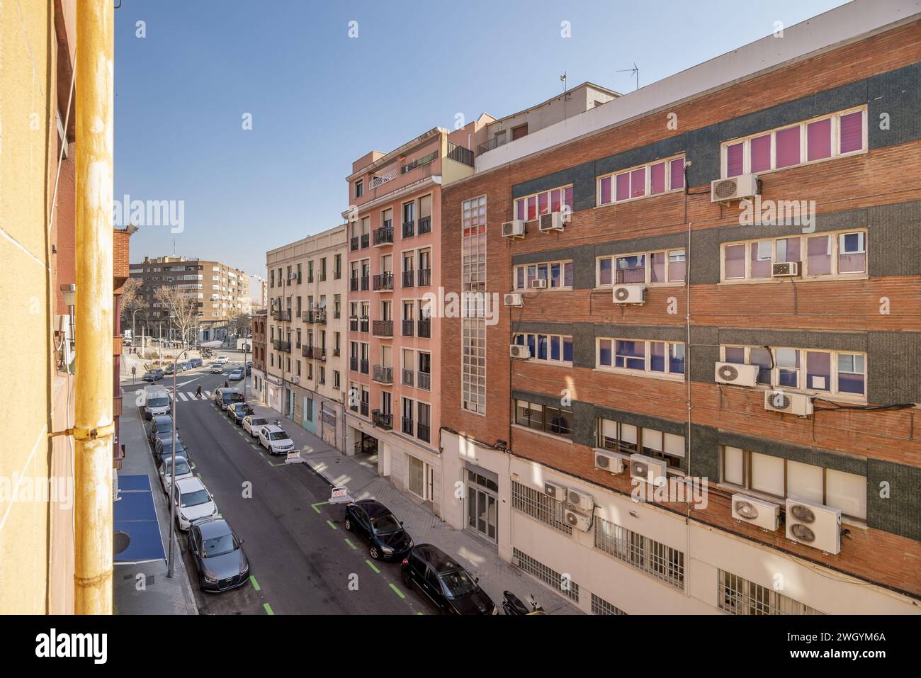 Une rue centrale dans la ville de Madrid avec des voitures garées des deux côtés par une journée ensoleillée Banque D'Images