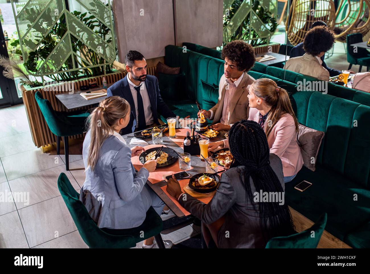 Groupe de gens d'affaires dans le restaurant au déjeuner. Banque D'Images