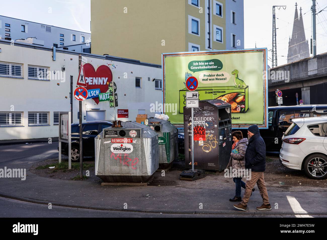 Récipient en verre usagé, récipient de vêtements usagé et panneau d'affichage sur la rue am Salzmagzin dans le quartier Eigelstein, en arrière-plan la cathédrale, Co Banque D'Images