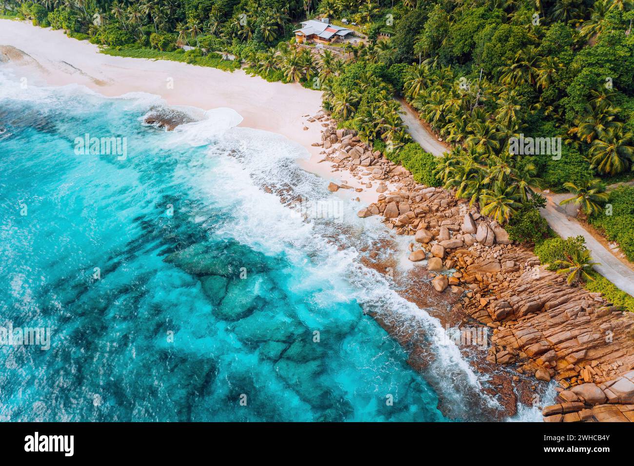 Vue aérienne de la plage tropicale de rêve Anse Bazarca, île de Mahé, Seychelles. Sable blanc poudreux, eau Azur, végétation luxuriante, roches granitiques. Banque D'Images
