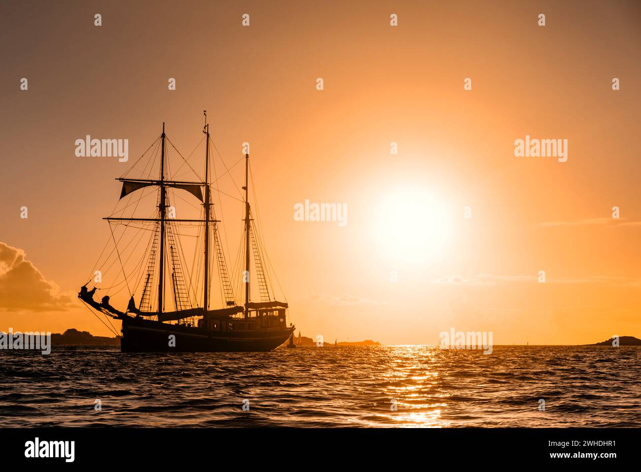 Un trois maîtres est ancré au large de la côte ouest française en Bretagne au coucher du soleil, couleurs chaudes, ambiance de vacances Banque D'Images