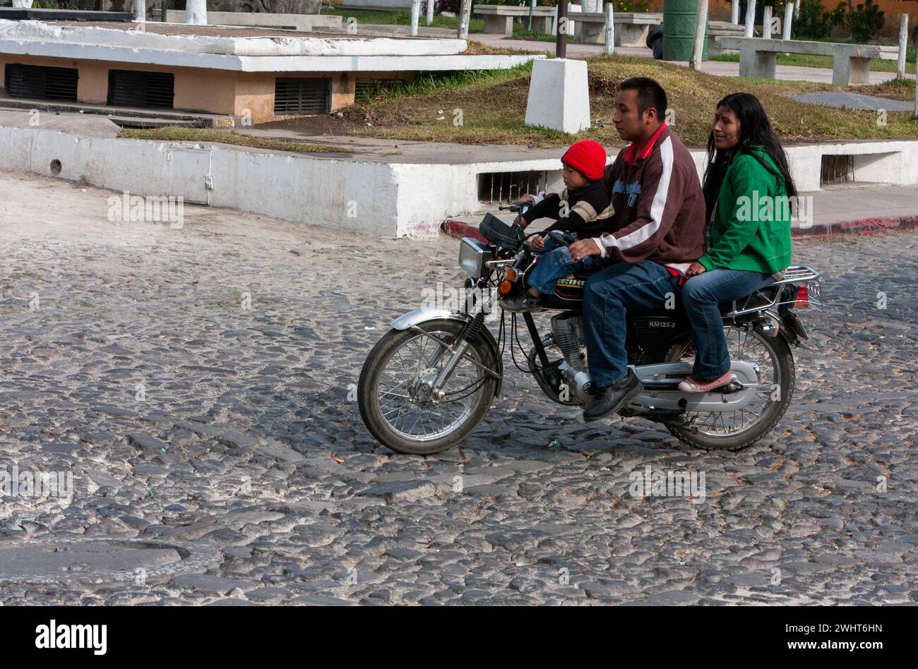 Antigua, Guatemala. Parents et fils à moto, pas de casque. Banque D'Images