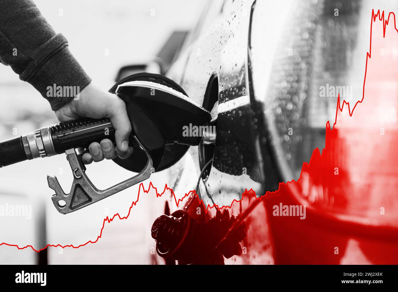 Main avec la buse de carburant et le graphique croissant montrant l'augmentation du prix de l'essence pendant la crise énergétique Banque D'Images