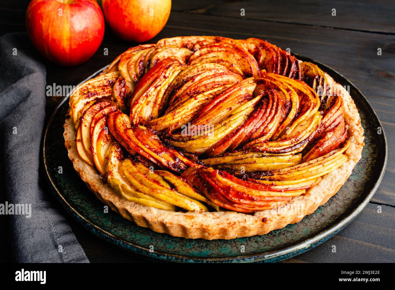 Tarte aux pommes végétaliennes fraîchement cuite sur une table rustique en bois : une tarte faite avec de la cannelle, des tranches Ambrosia, Golden Delicious et des pommes Granny Smith Banque D'Images