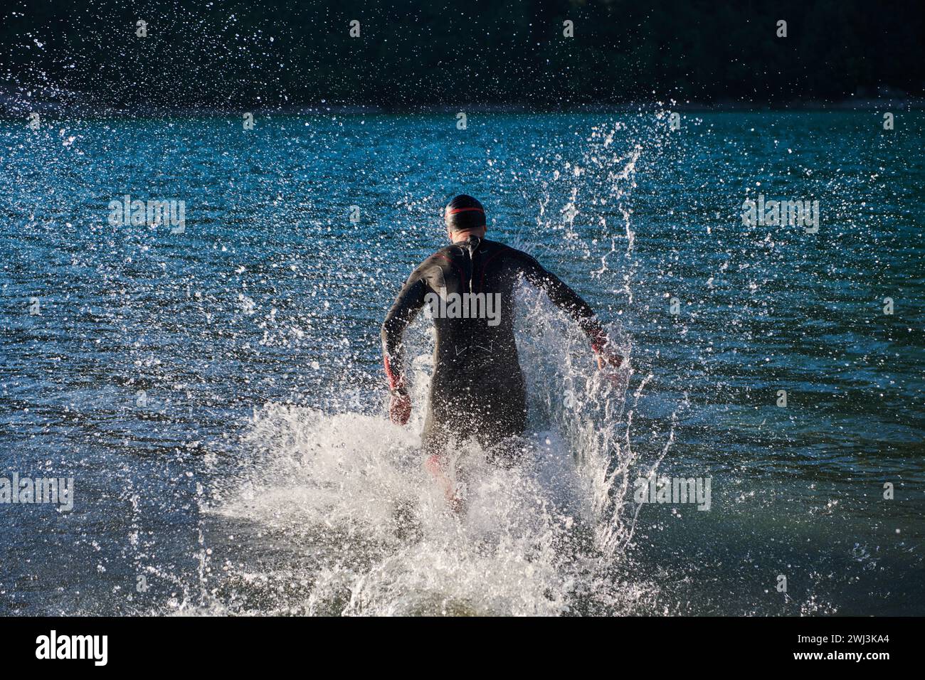 Athlète de triathlon commençant l'entraînement de natation sur le lac Banque D'Images