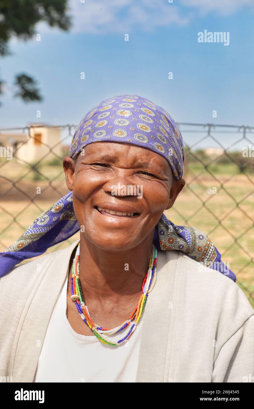 village souriant vieille femme africaine portant un collier traditionnel de perles, avec un visage heureux, Banque D'Images