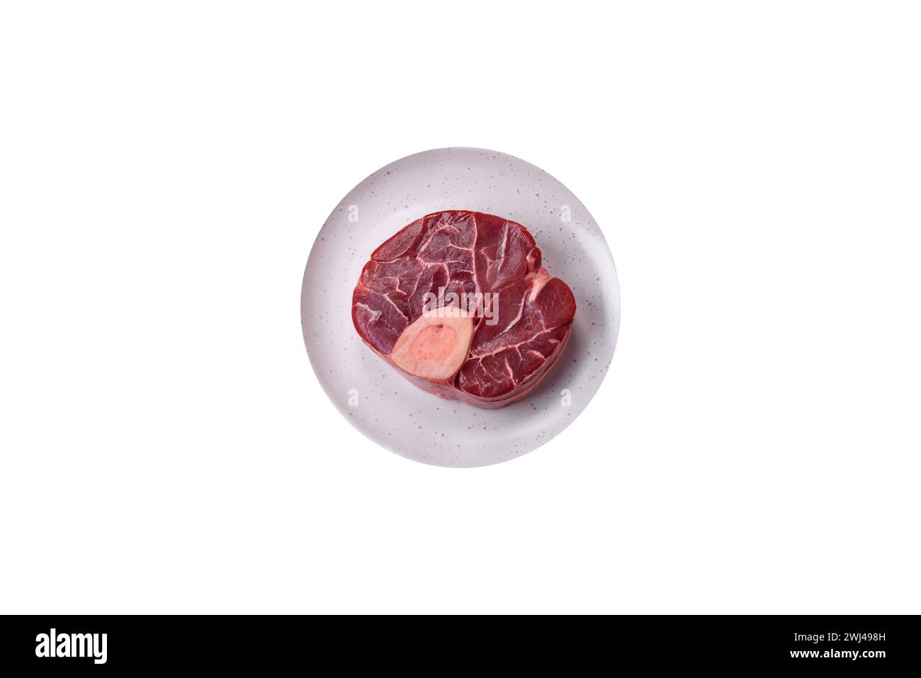 Steak de bœuf cru frais avec os ou ossobuco avec sel, épices et herbes Banque D'Images