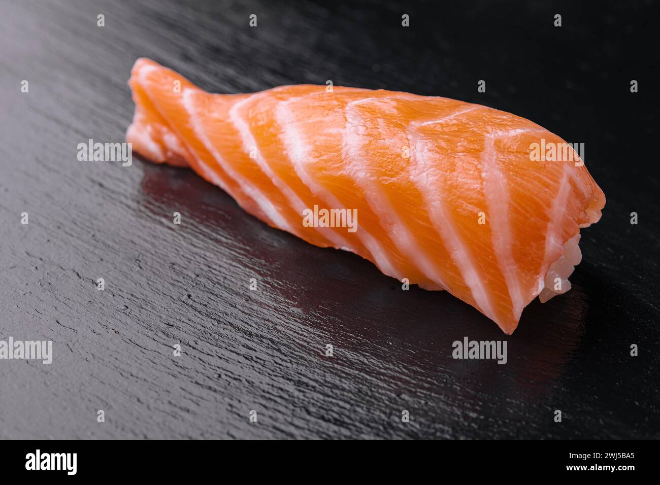 Sushi de saumon japonais sur la table en bois noir Banque D'Images